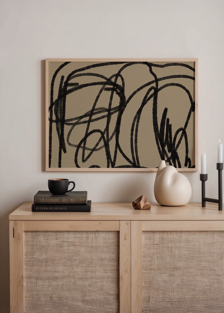 Abstract wall art featuring bold black lines on a beige background.