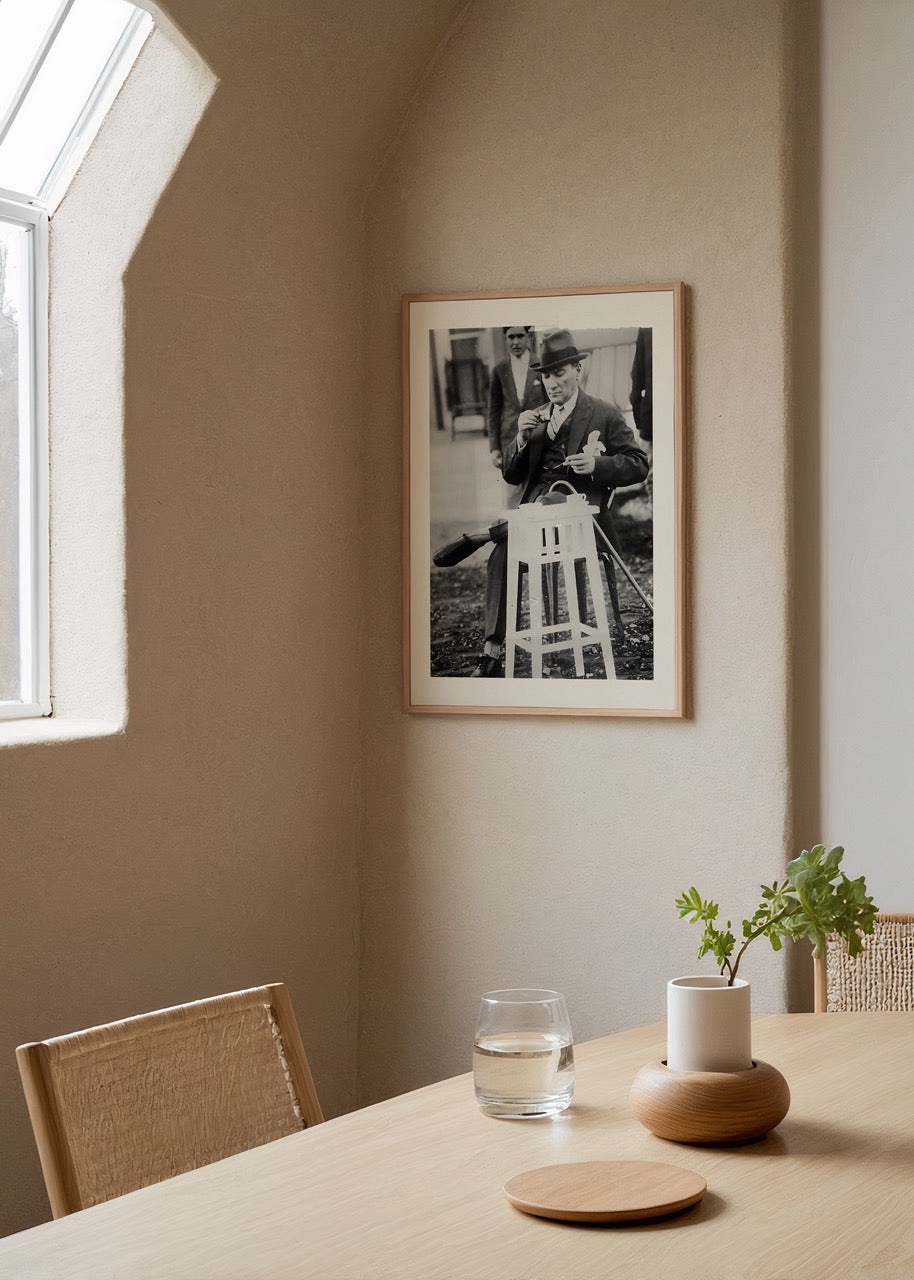 A serene black and white poster of a man enjoying tea during a break, adding elegance to your wall art collection.