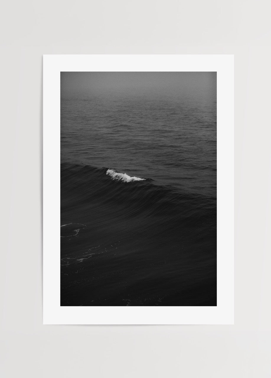 Black and white photography of ocean waves, evoking calmness and elegance.