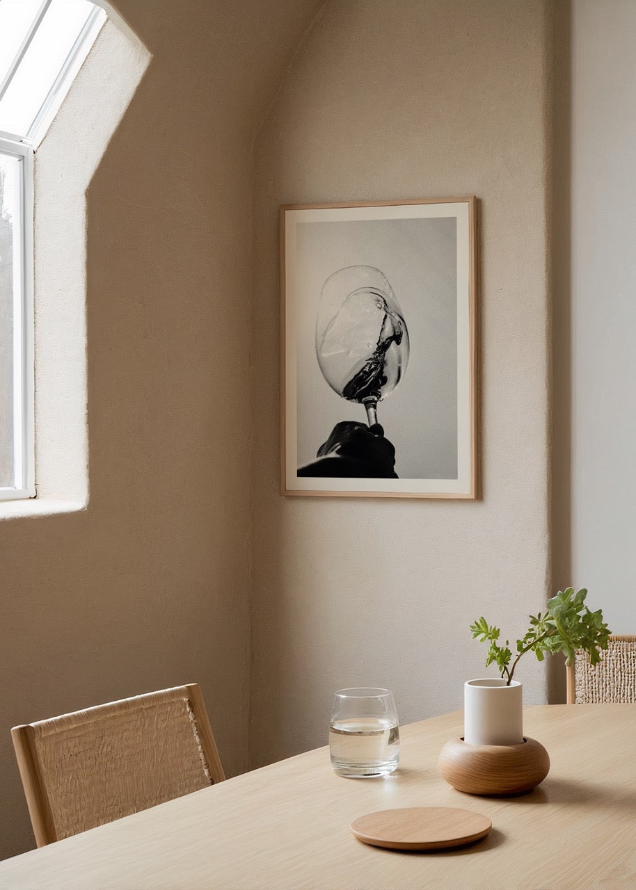 Black and white print of a wine glass in motion, showcasing elegance and minimalism.