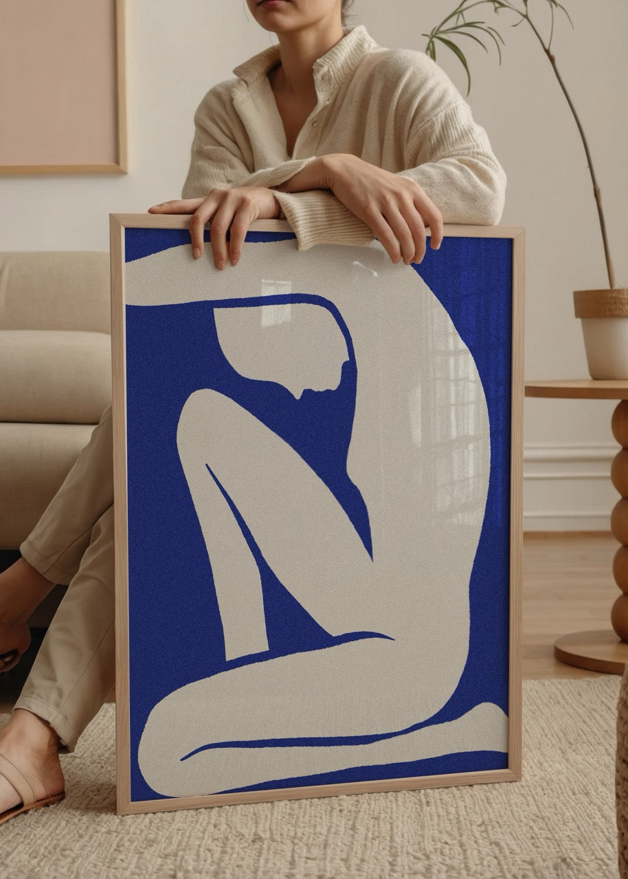 A striking blue silhouette of a figure in a relaxed pose.