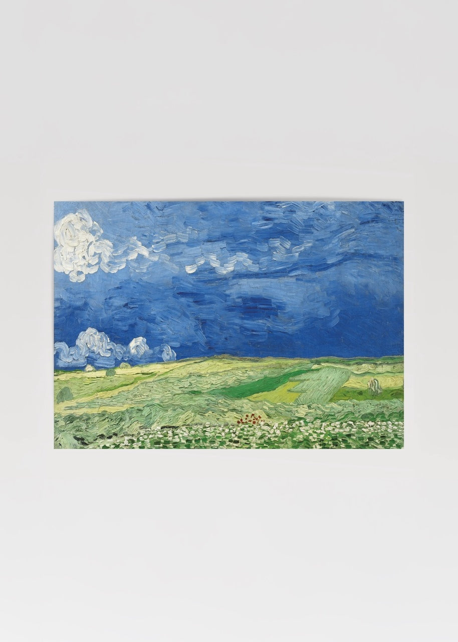 Vibrant landscape of golden fields under a dramatic cloudy sky.