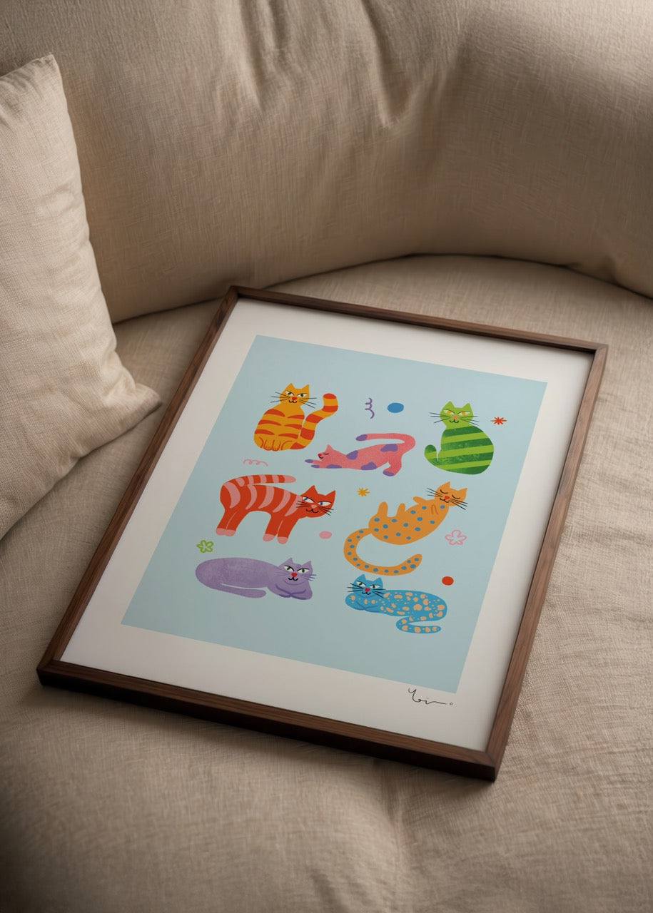 Vibrant artwork featuring playful cats in various poses on a blue background.
