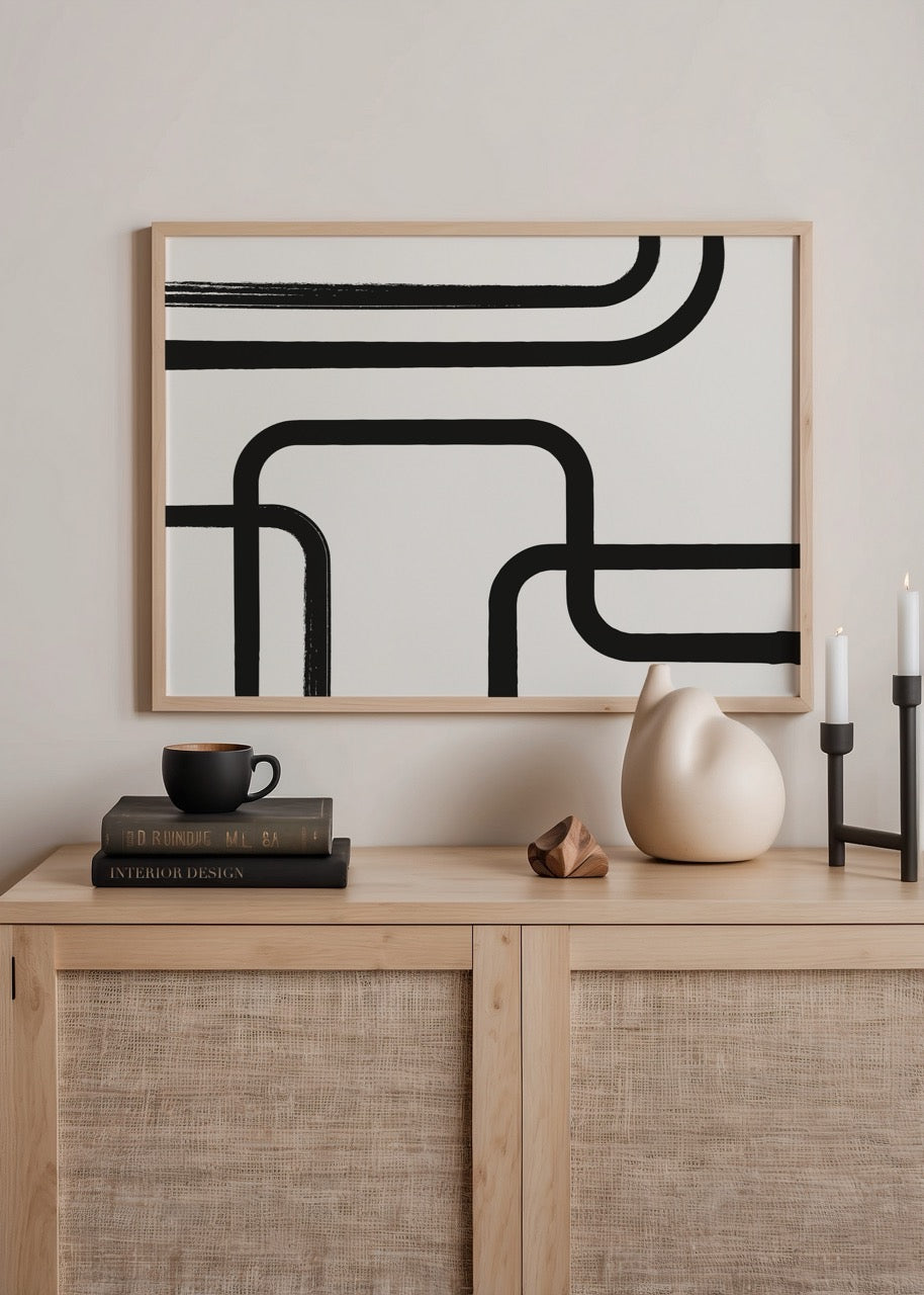 Monochrome abstract art print featuring flowing black lines on a white background.
