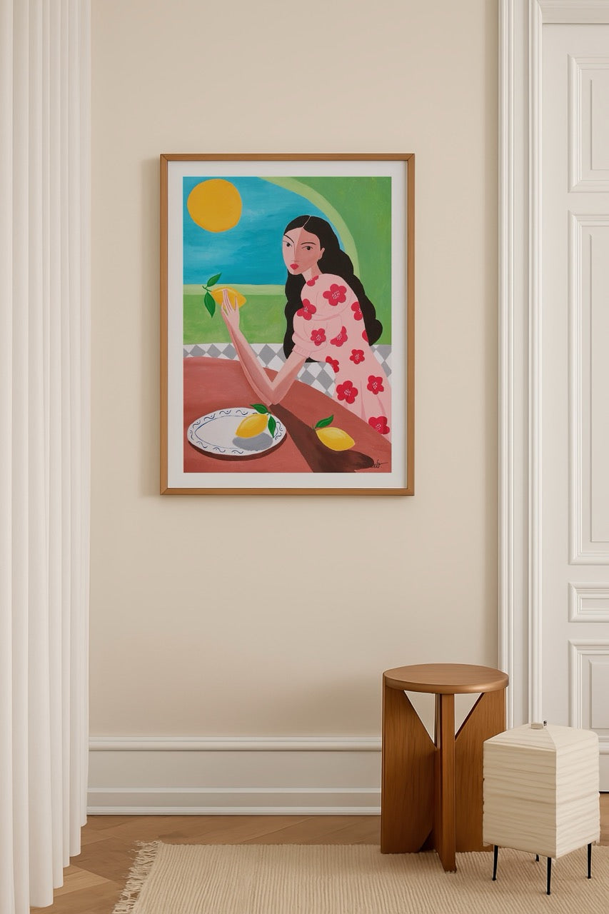 A vibrant poster print featuring a woman holding a lemon against a sunny backdrop.