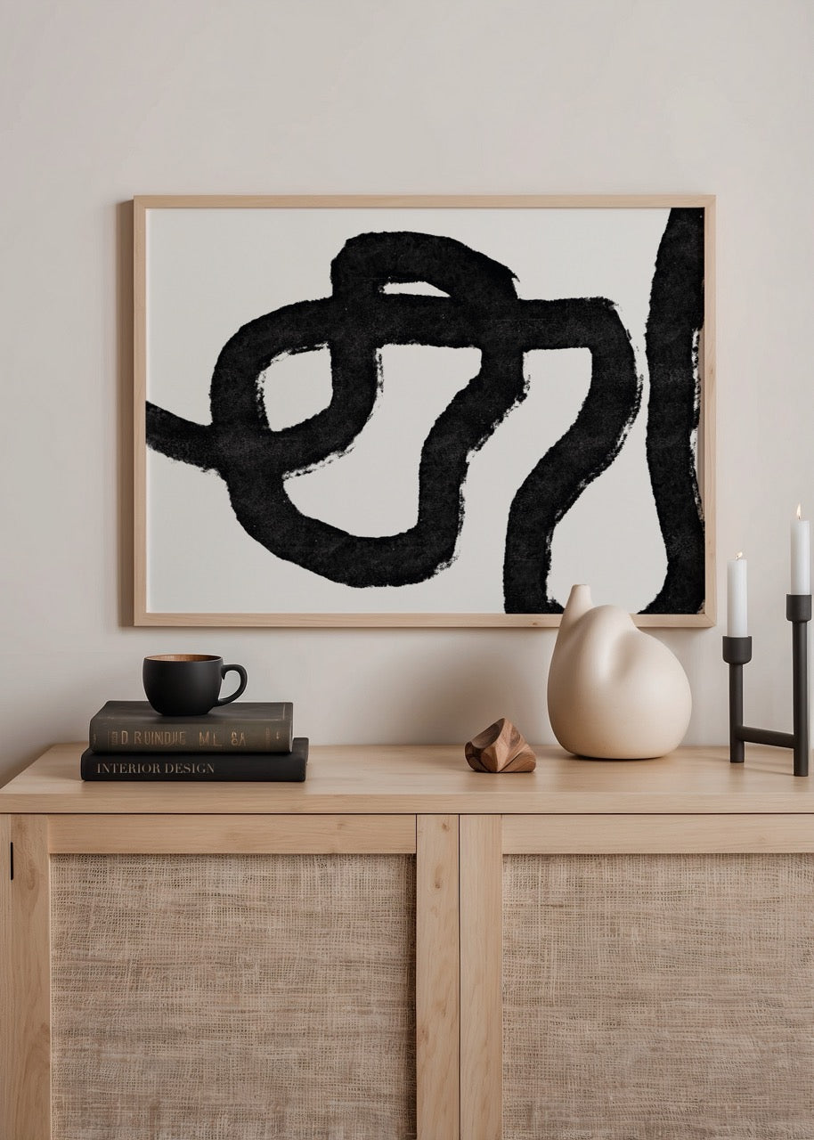 Abstract art print featuring fluid black lines on a white background.