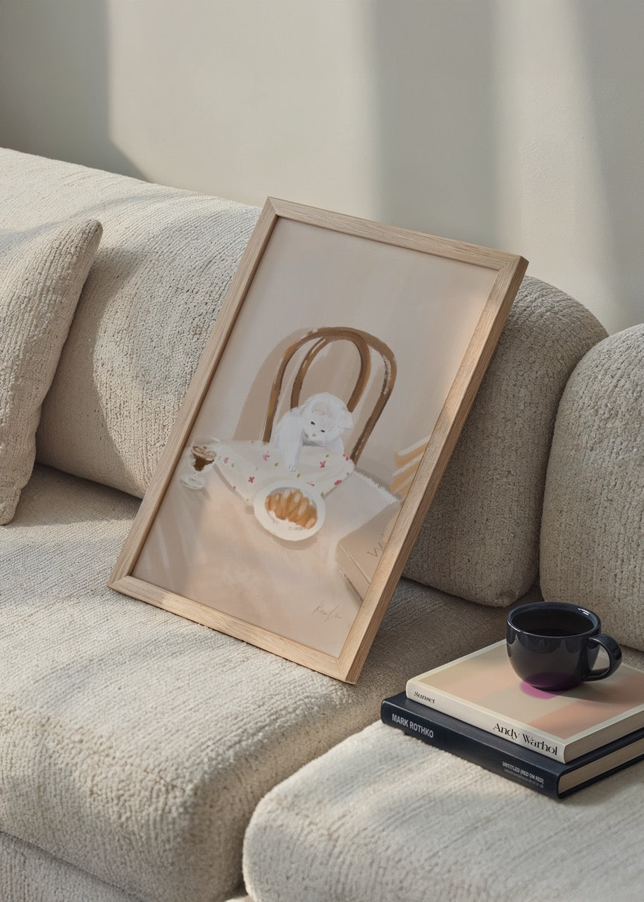 Charming illustration of a cat beside a croissant on a table, evoking warmth and comfort.
