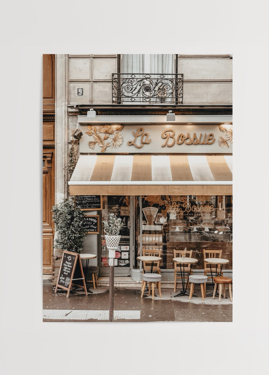 Charming wall art of a café facade, evoking Parisian elegance.