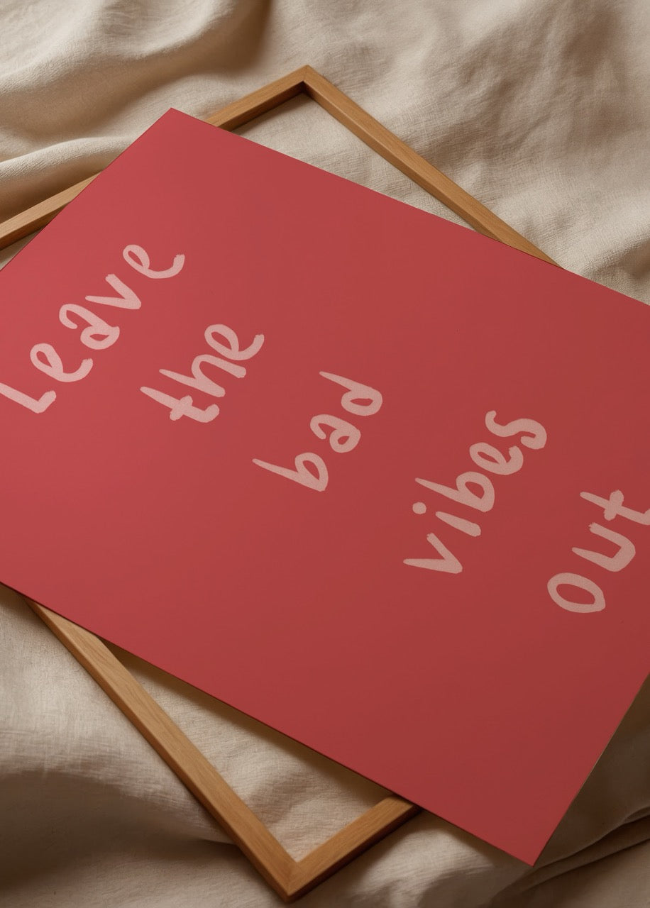 Leave the Bad Vibes Out poster in vibrant red with playful typography.