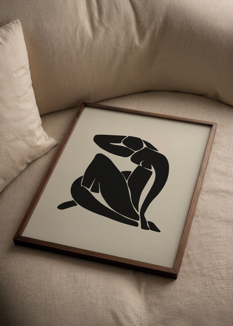 Contemporary silhouette art print in black on beige background, featuring abstract seated figure.