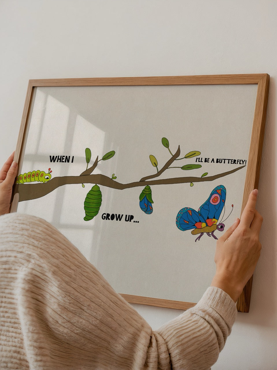 Metamorphosis poster featuring a caterpillar, chrysalis, and butterfly with a whimsical design.