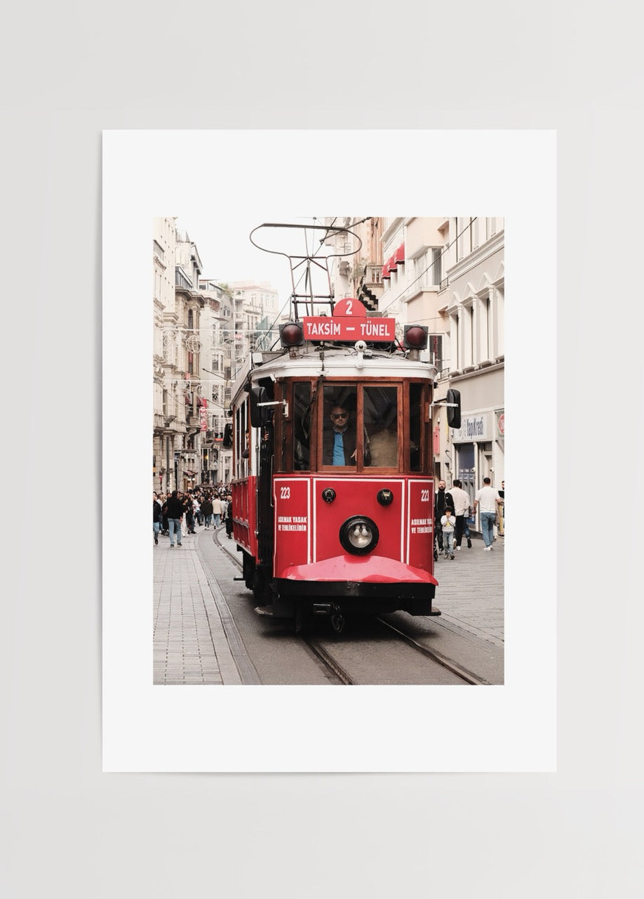 A vibrant red tram in a city street, capturing nostalgic urban charm.