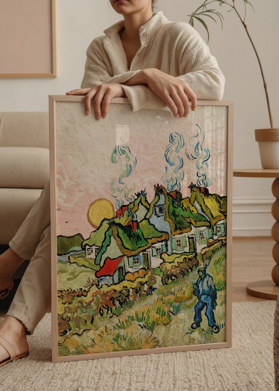 A vibrant countryside scene featuring thatched cottages against a warm sunset sky.