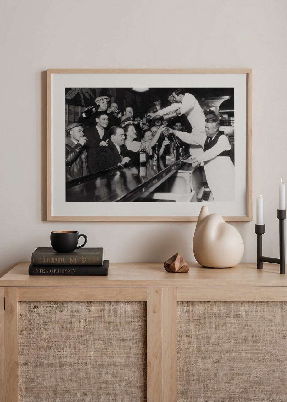 Vintage black and white print of a bustling bar scene.