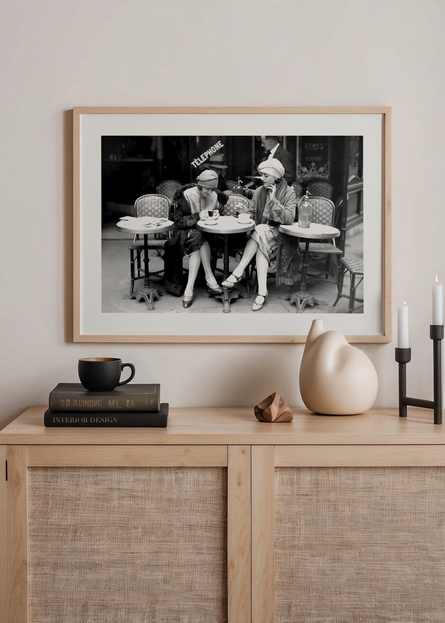 Vintage black and white photograph of two women at a Paris café.