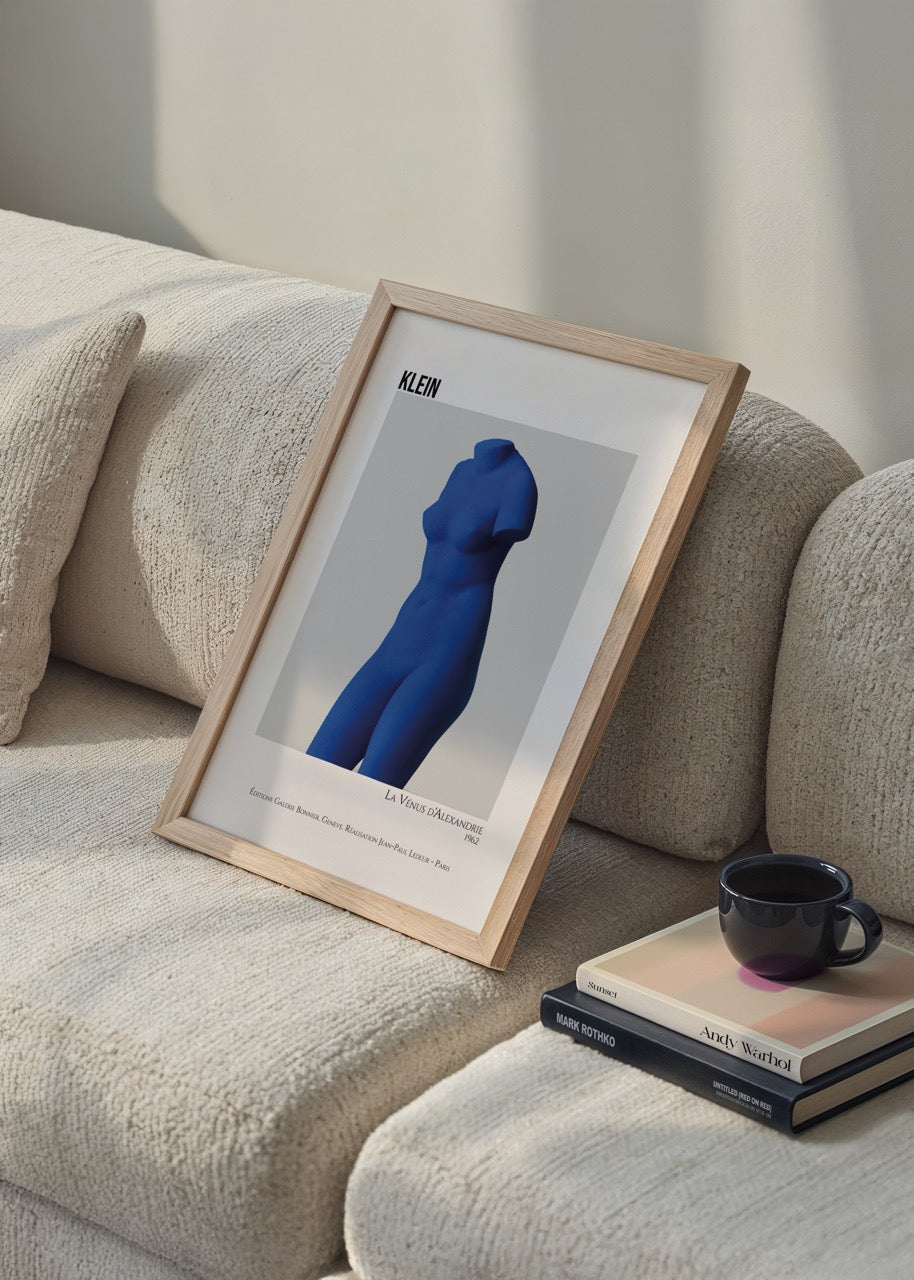 A bold blue sculptural figure featured in minimalist wall art.