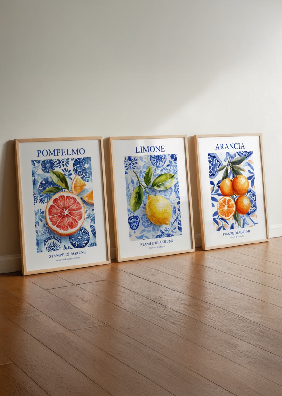 Three-piece poster set featuring grapefruit, lemon, and orange illustrations on a floral blue background.