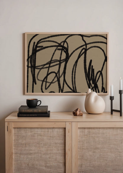 Abstract wall art featuring bold black lines on a beige background.
