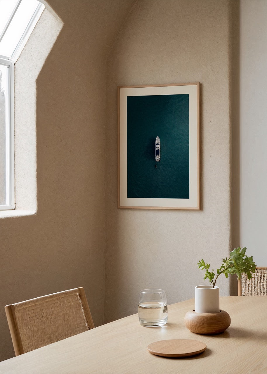 A minimalist art print of a solitary boat on tranquil blue waters.