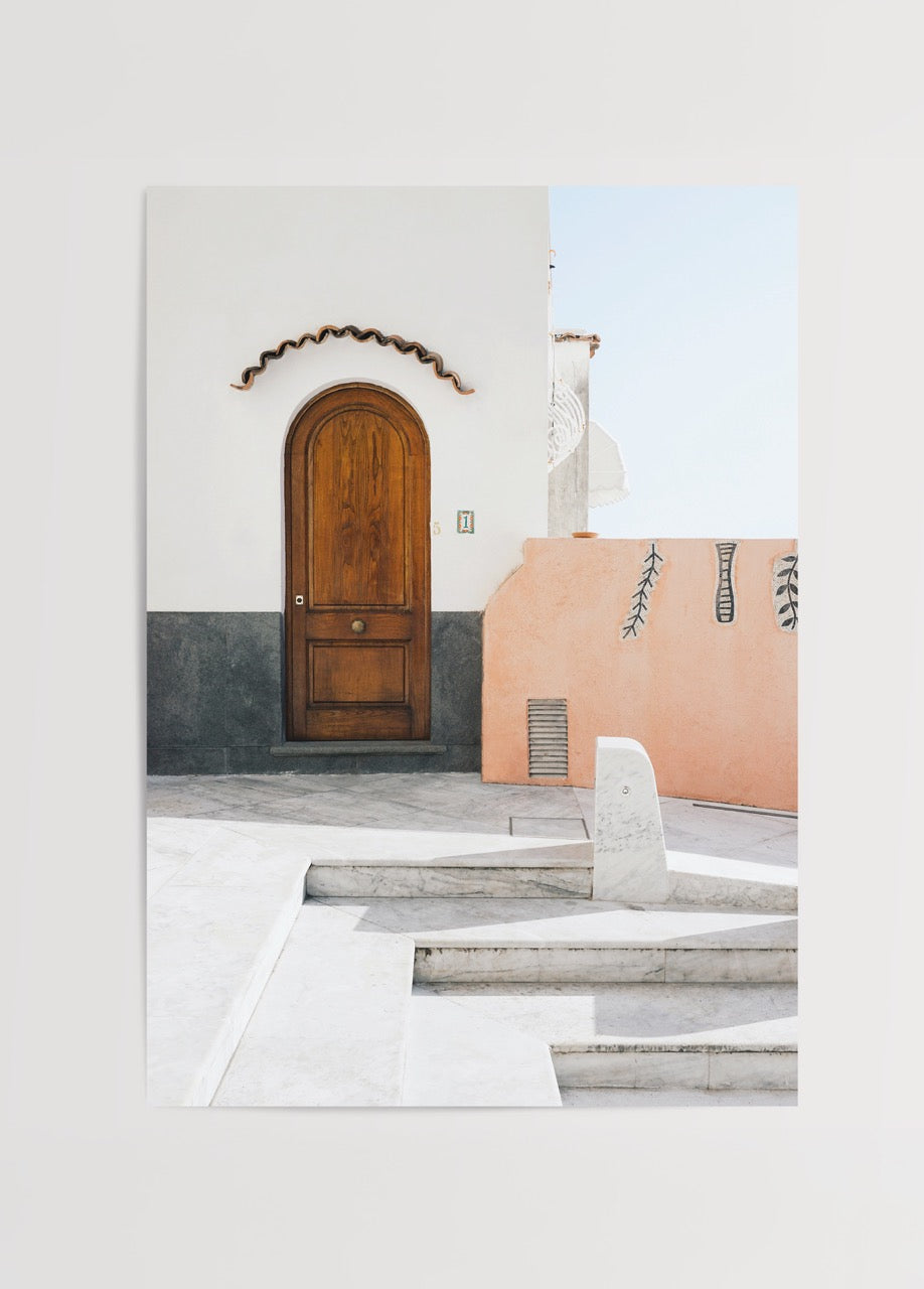 Mediterranean architecture featuring a wooden door and textured wall.
