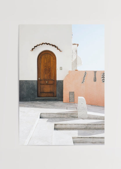 Mediterranean architecture featuring a wooden door and textured wall.
