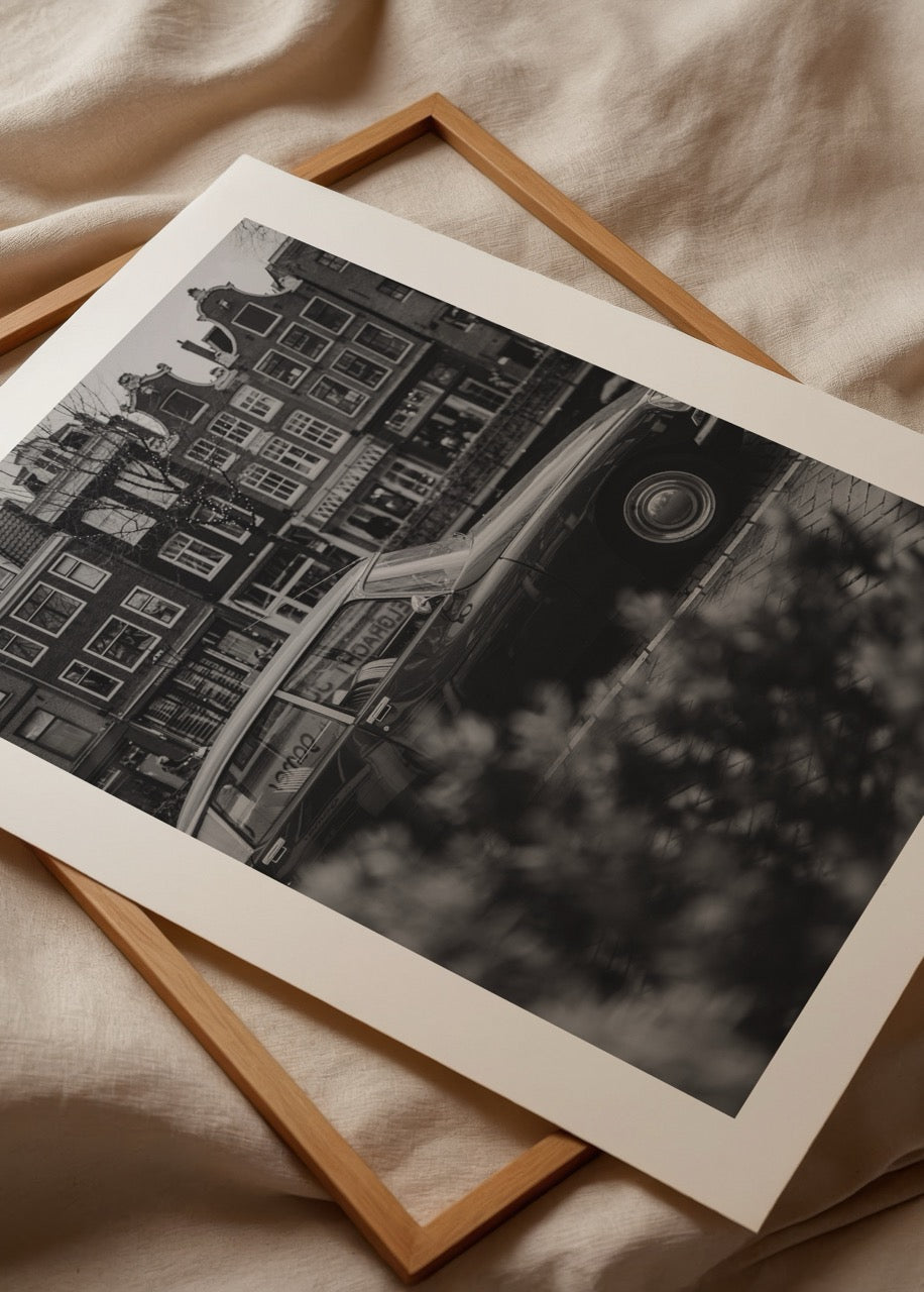 Black and white vintage car photograph in Amsterdam, evoking nostalgia.