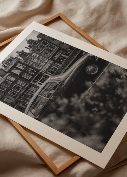Black and white vintage car photograph in Amsterdam, evoking nostalgia.