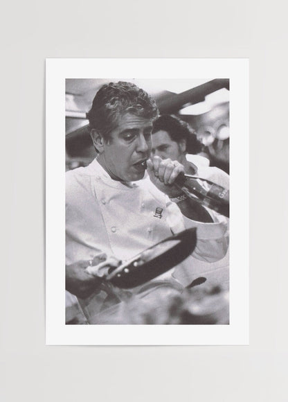 Black and white poster depicting a chef passionately cooking in a kitchen.