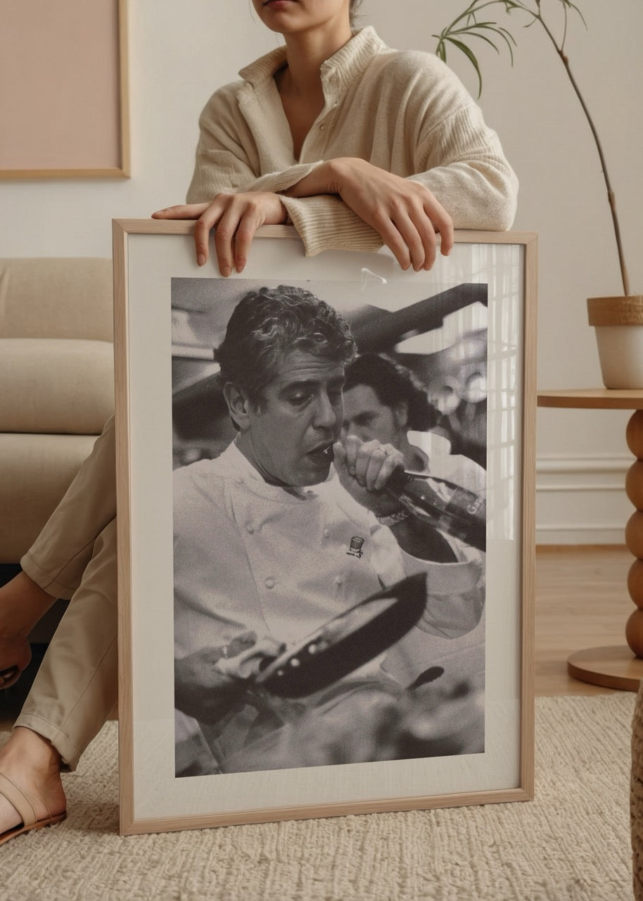 Black and white poster depicting a chef passionately cooking in a kitchen.