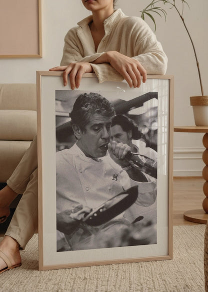 Black and white poster depicting a chef passionately cooking in a kitchen.