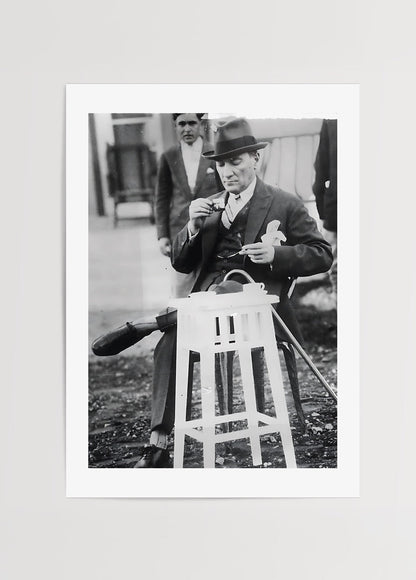 A serene black and white poster of a man enjoying tea during a break, adding elegance to your wall art collection.