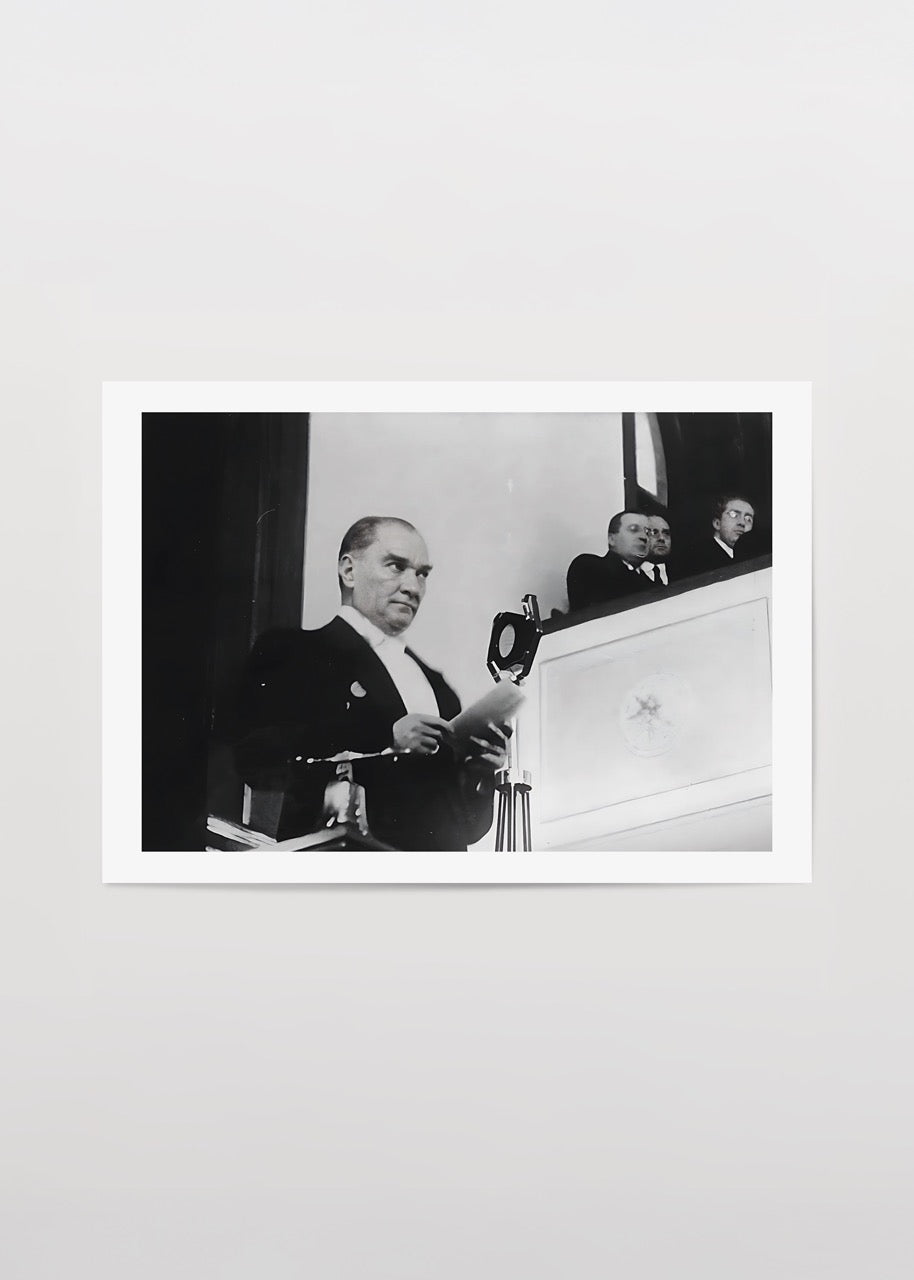 A historic black and white print capturing a moment of leadership during an address.