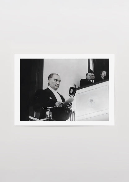 A historic black and white print capturing a moment of leadership during an address.