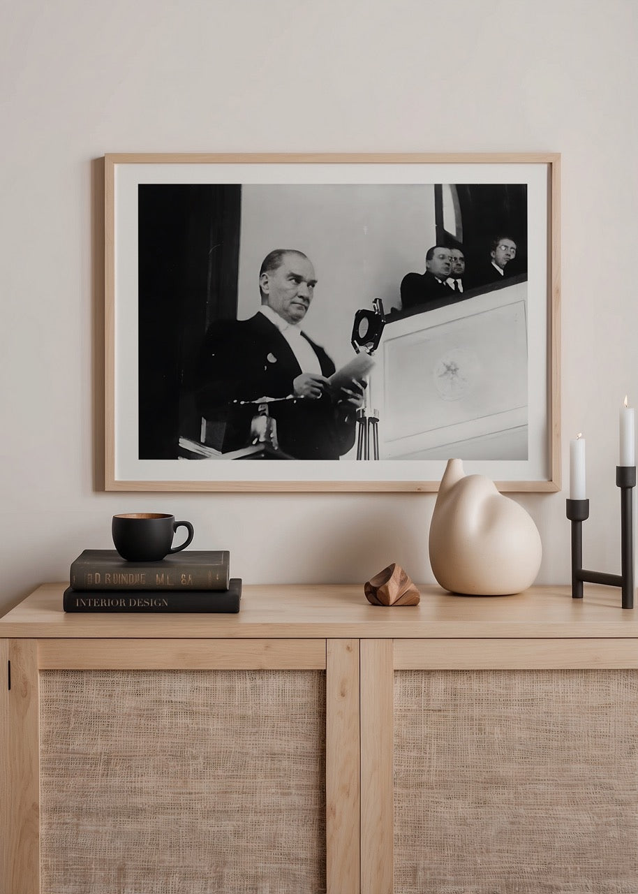 A historic black and white print capturing a moment of leadership during an address.