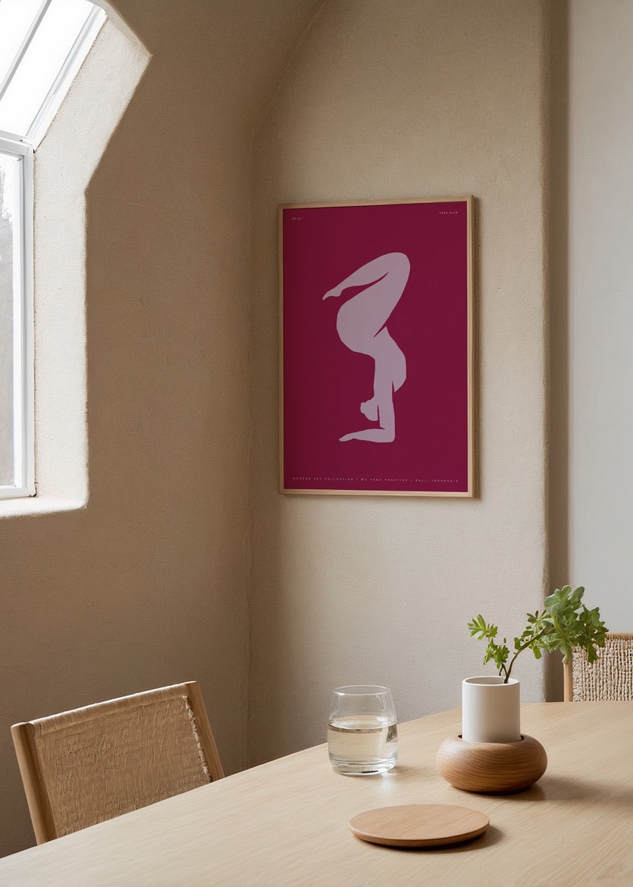 Minimalist wall art featuring a graceful silhouette on a maroon background.