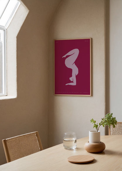 Minimalist wall art featuring a graceful silhouette on a maroon background.