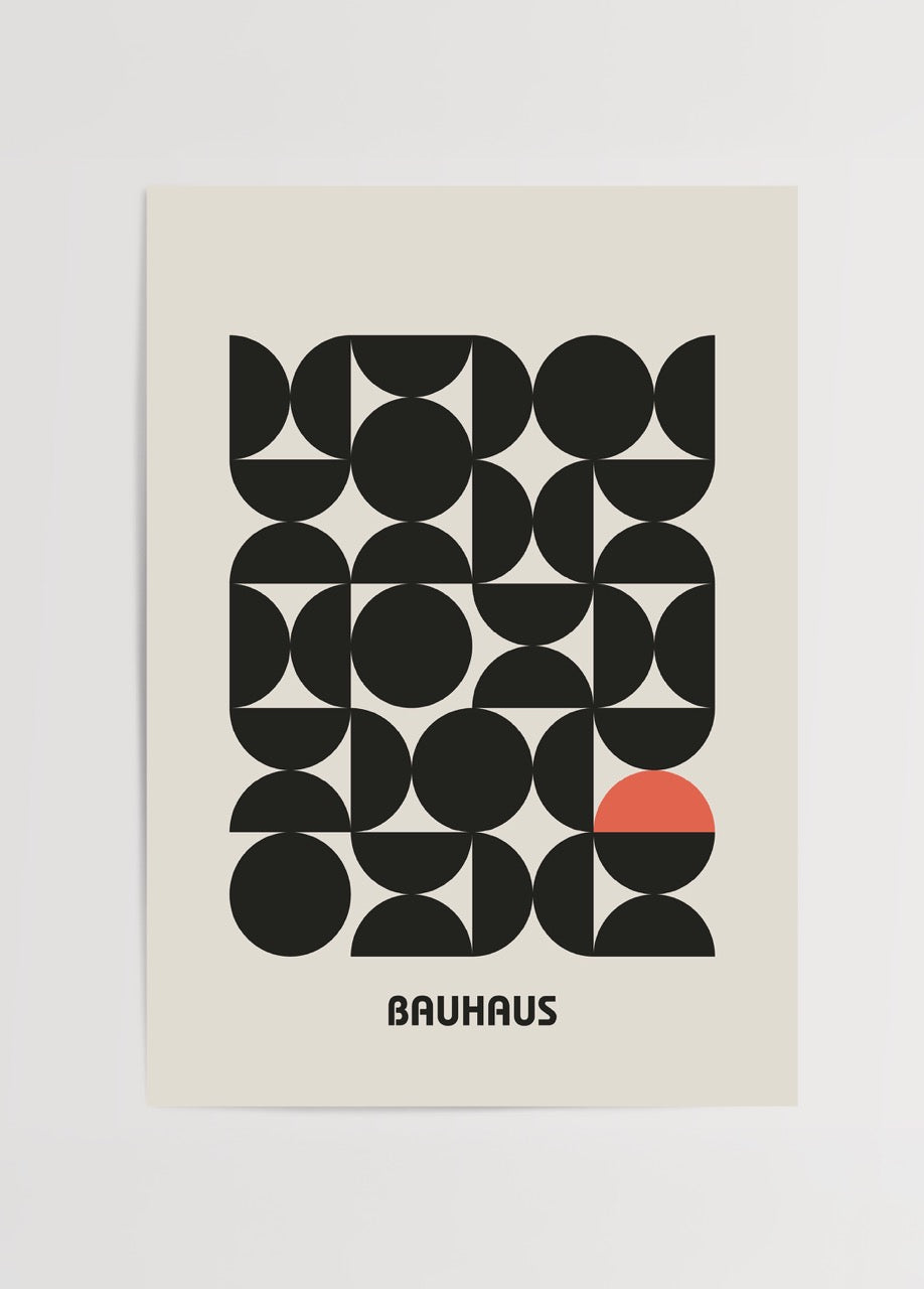 Geometric wall art featuring black shapes and a red accent.
