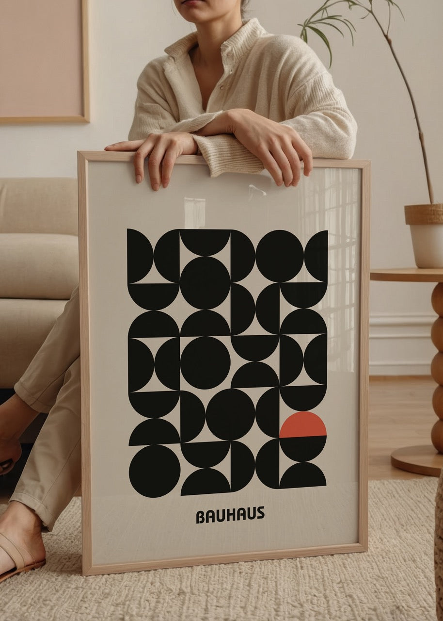 Geometric wall art featuring black shapes and a red accent.