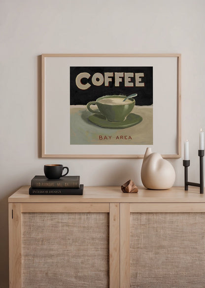 Artwork featuring a retro green coffee cup with the word &