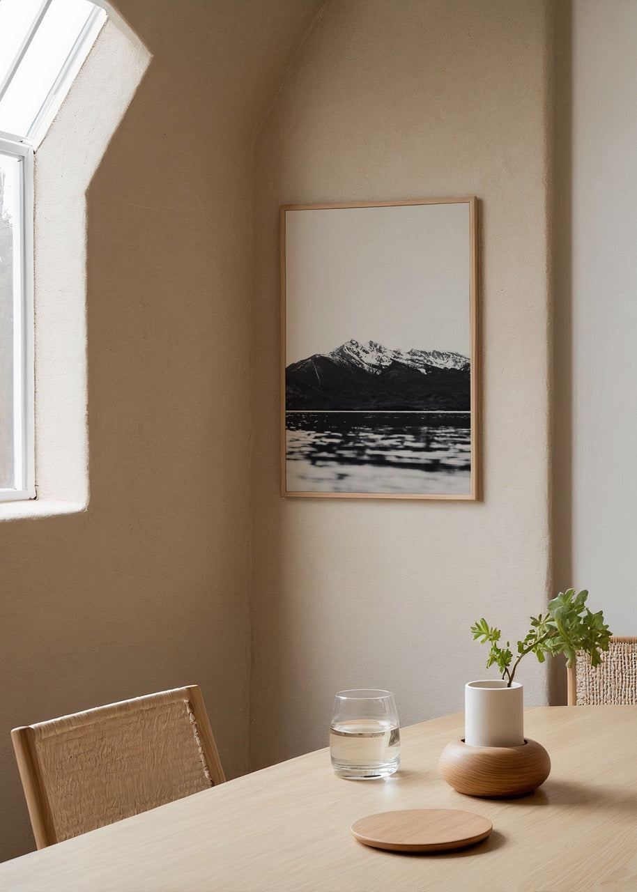 Monochrome artwork of mountains and lake reflecting calm waters