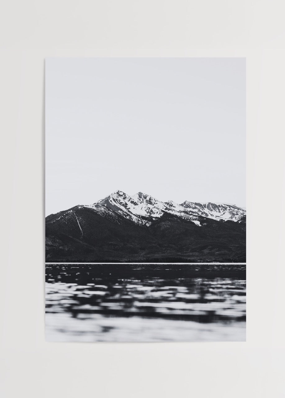 Monochrome artwork of mountains and lake reflecting calm waters
