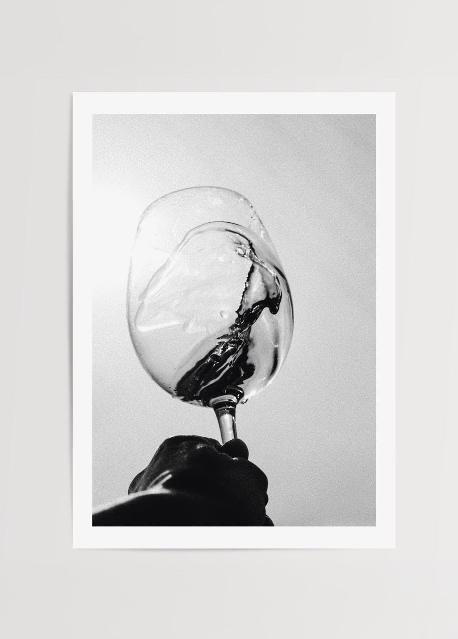 Black and white print of a wine glass in motion, showcasing elegance and minimalism.