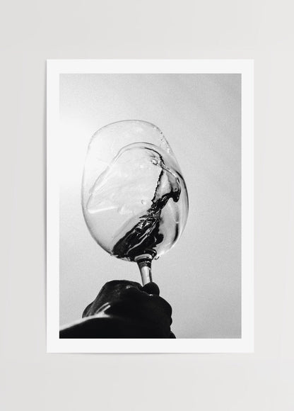 Black and white print of a wine glass in motion, showcasing elegance and minimalism.