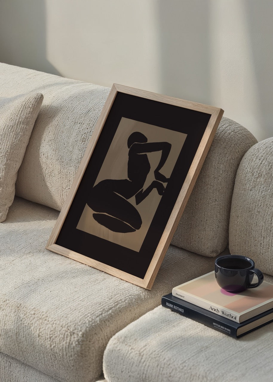 Abstract wall art featuring a dark form on a beige background.