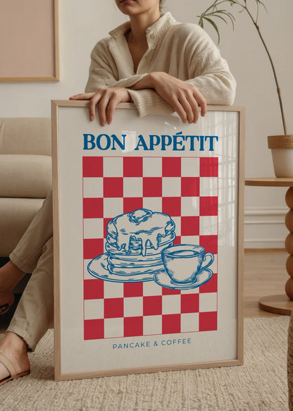 A vibrant poster print featuring pancakes and coffee on a red and white checkered background.