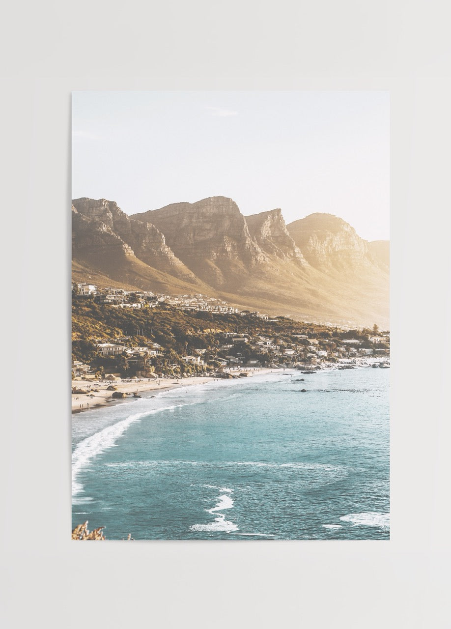 A serene coastal view of Cape Town with golden sands and blue ocean waves.