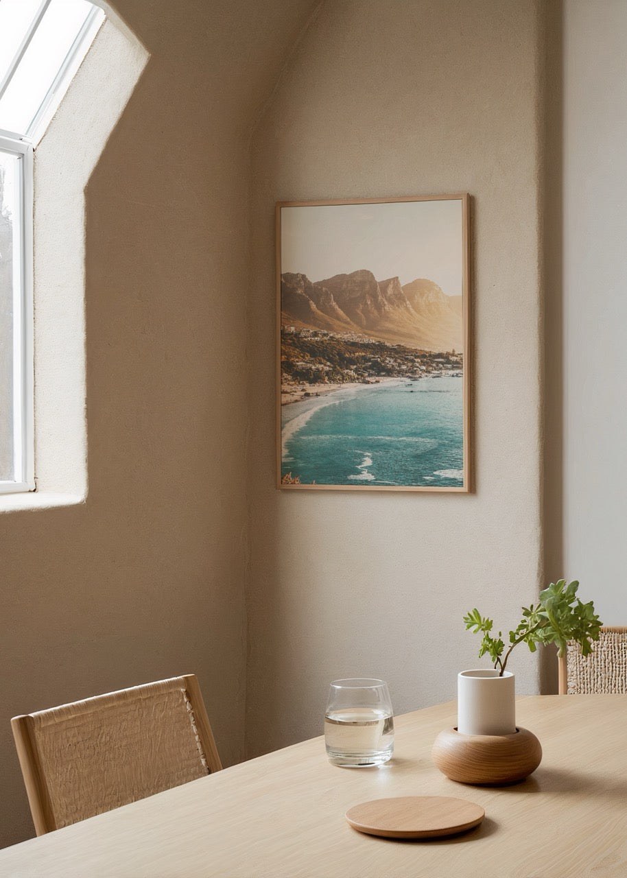 A serene coastal view of Cape Town with golden sands and blue ocean waves.