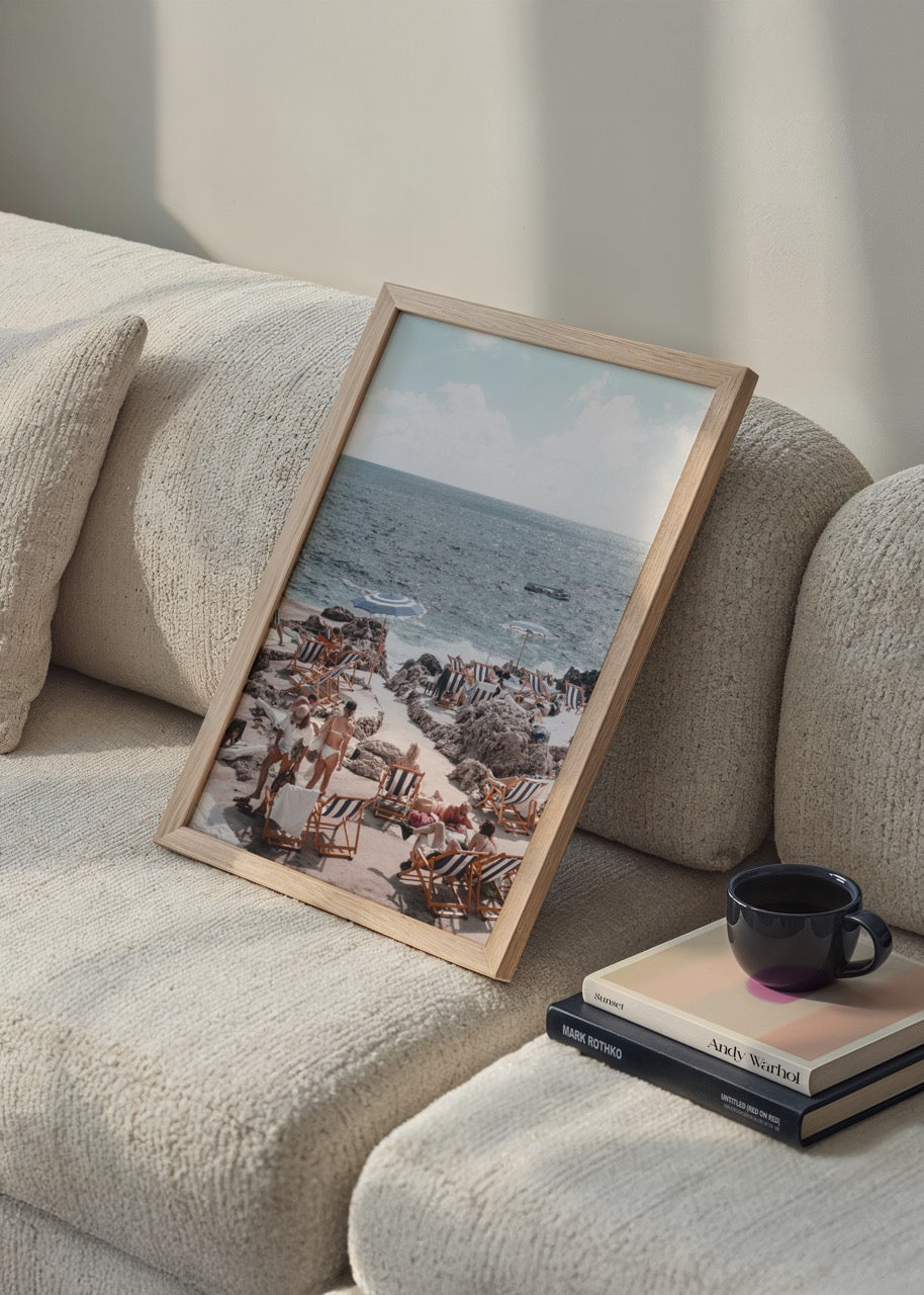A serene beach scene at Capri with sun loungers and clear blue sea.