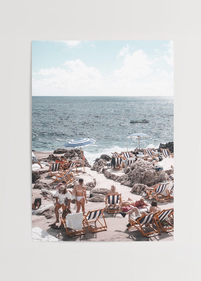 A serene beach scene at Capri with sun loungers and clear blue sea.