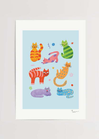 Vibrant artwork featuring playful cats in various poses on a blue background.